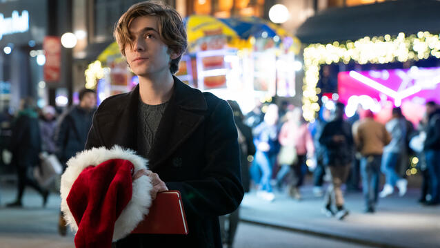 Bild zeigt jungen mit Weihnachtsmütze in der Hand